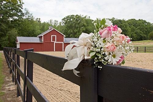 picture of barn with bouquet on fence